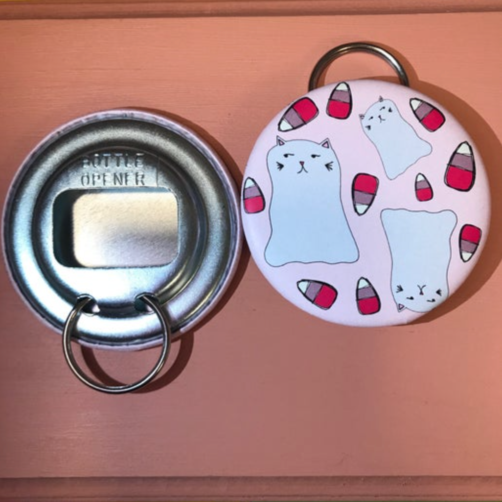 Bottle opener keychain with our Ghost Kitty Pattern. A suspicious looking white ghost cat is surrounded by falling candy corn. 