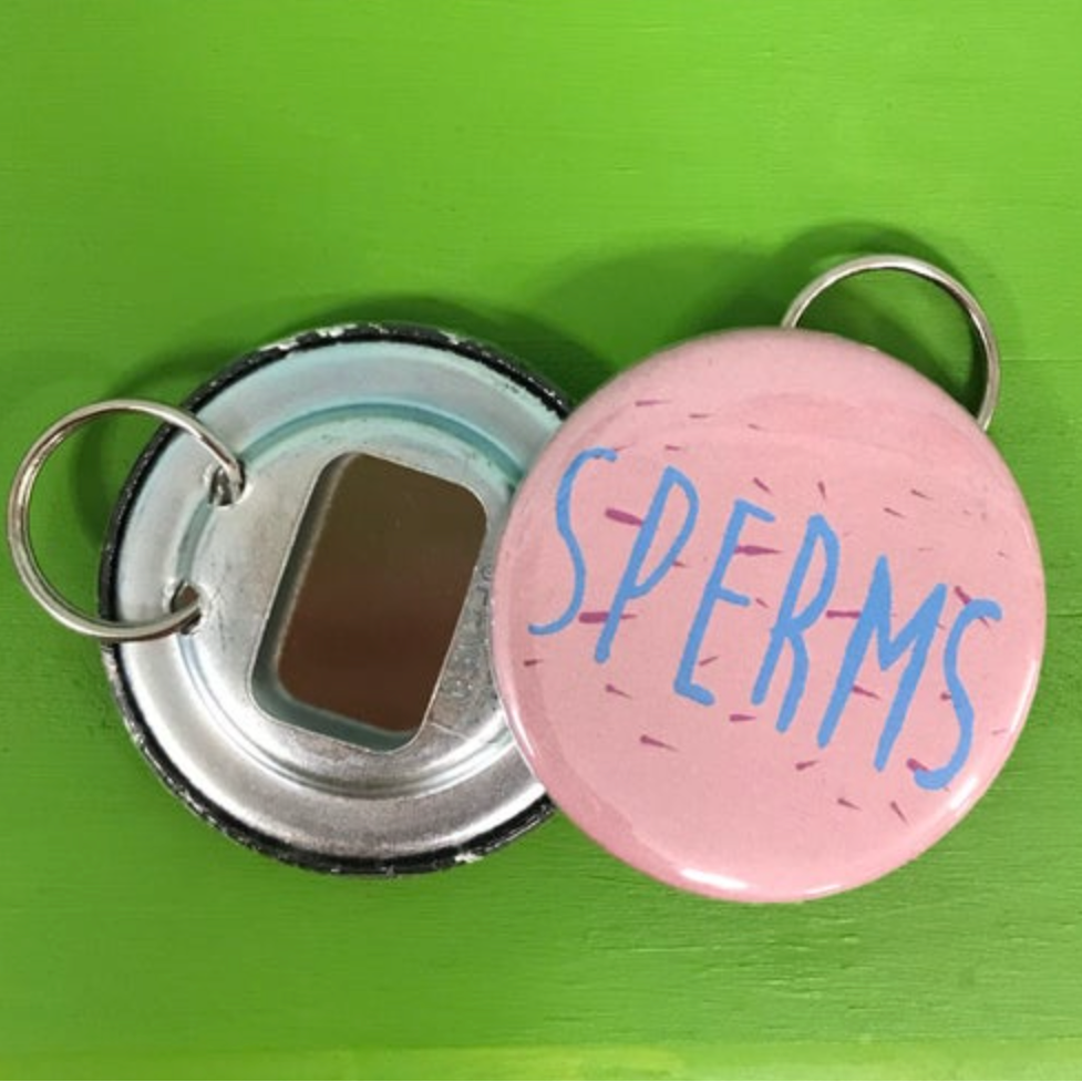Two bottle openers with one pink side that says 'SPERMS' on a green background. 