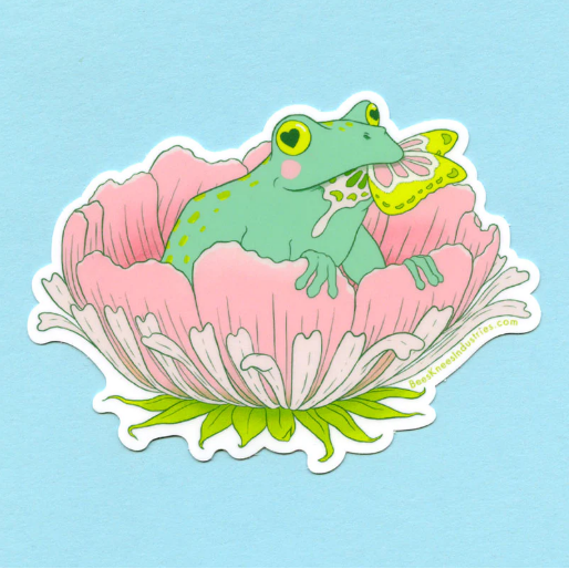 A sticker of a frog with hearts in its eyes sitting in a pink flower and eating a butterfly.