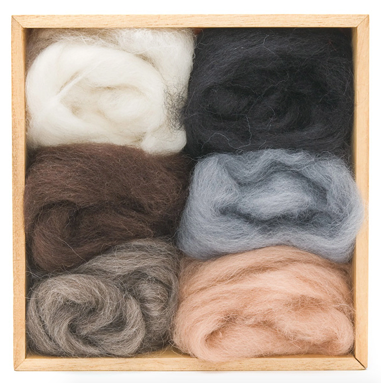 Set of different neutral colored wool rovings in a wooden box. 