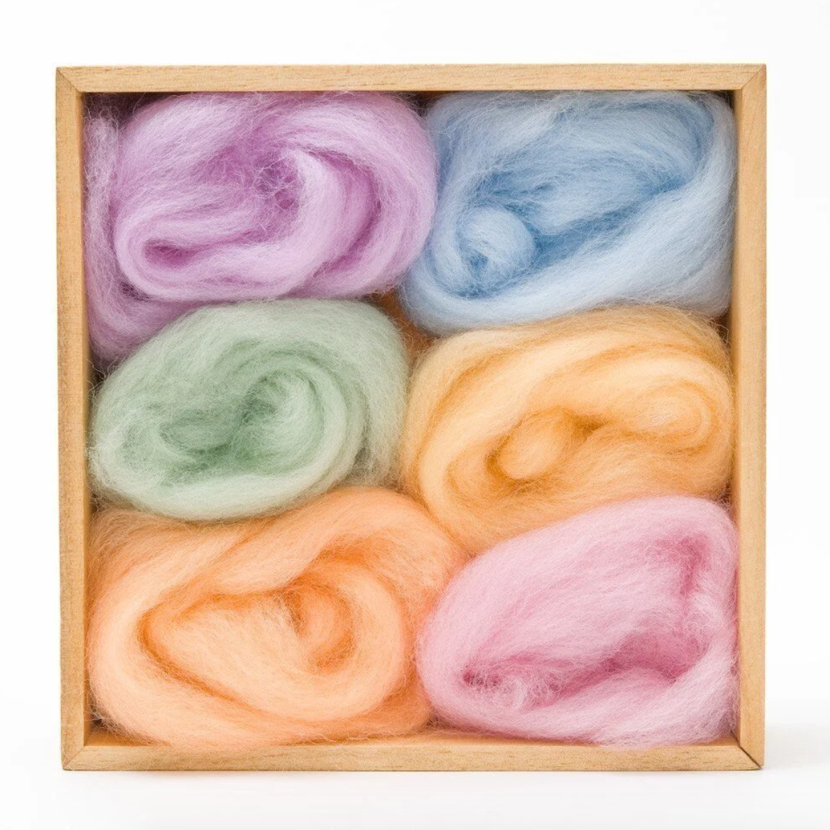 Set of colorful wool rovings in a wooden box on a white background. 