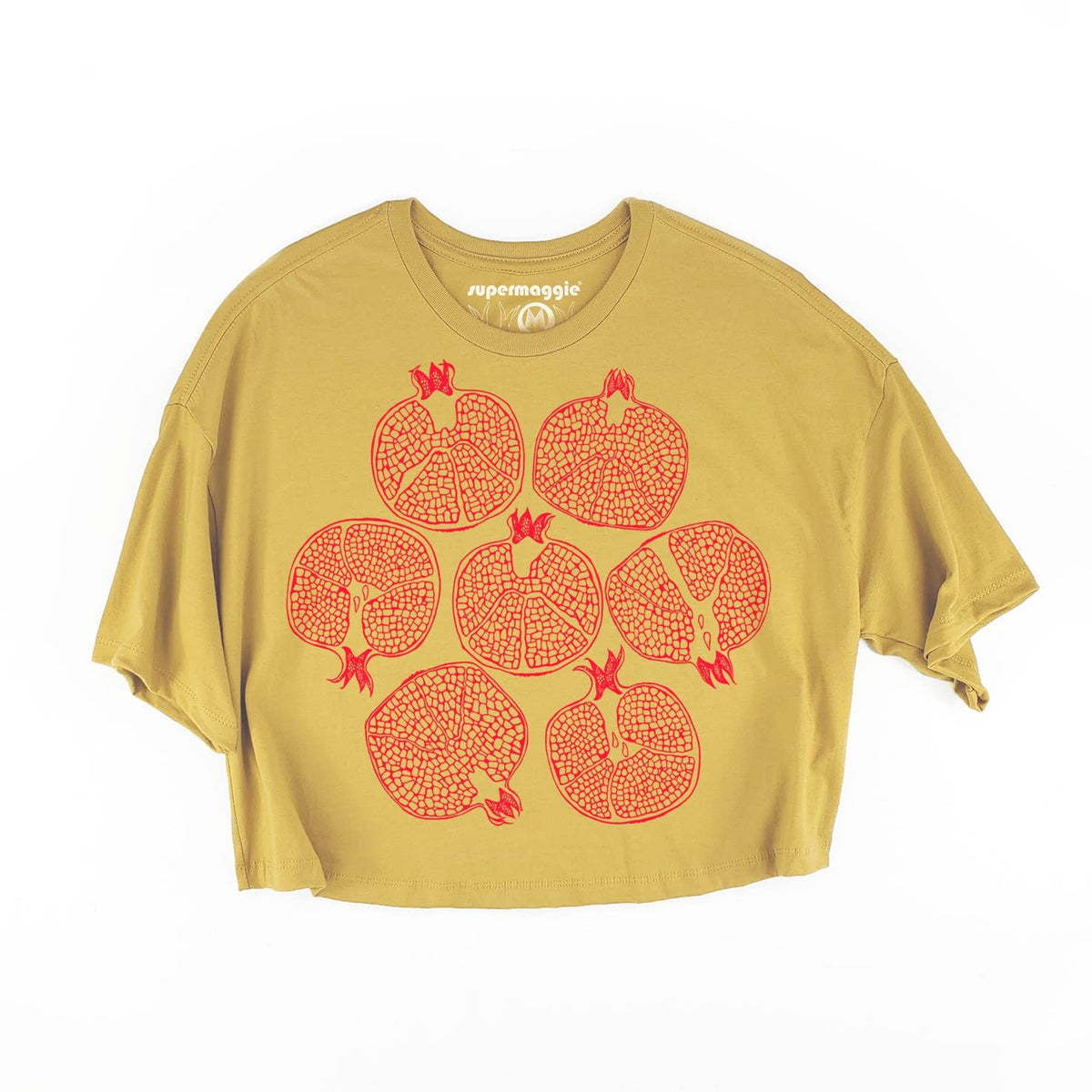 A cropped short-sleeve t-shirt in mustard yellow with a graphic print of seven red pomegranate illustrations on the front, displayed against a plain white background.