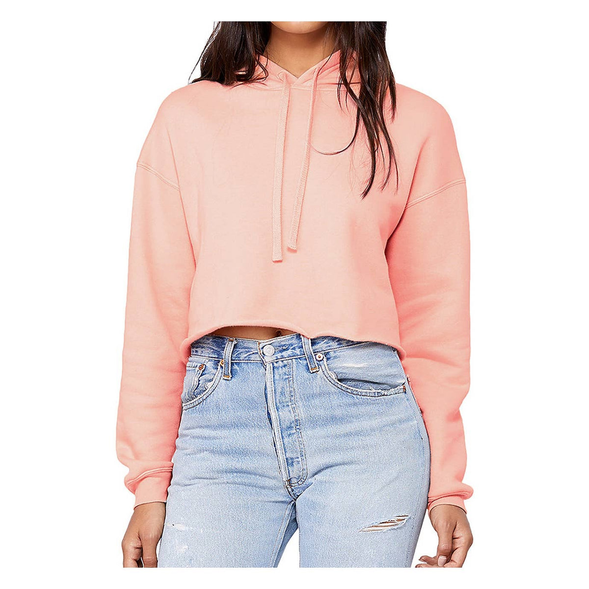 Person wearing an apricot cropped hoodie and light blue jeans on a white background. 