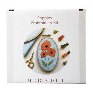 Embroidery kit packaging with poppies design on a white background. 
