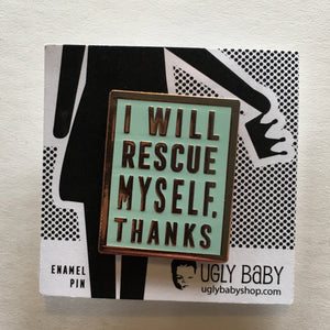 Mint colored rectangular enamel pin that says "I will rescue myself, thanks" in rose gold lettering. It is displayed on a black and white backing card. 