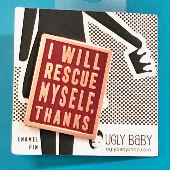 An enamel pin shaped like a rectangle with the text 'I WILL RESCUE MYSELF, THANKS.
