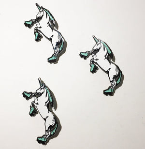 Three idential roller skating unicorn enamel pins with mint colored manes and roller skates.