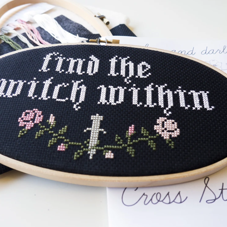 A close up photo of a finished "Find the Witch Within" cross stitch kit by Junebug and Darlin. 