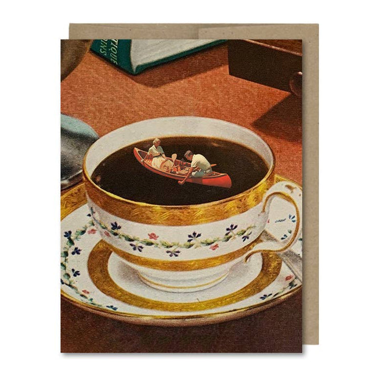 Teacup with miniature figures in a boat on a saucer -- on the front of a greeting card. 