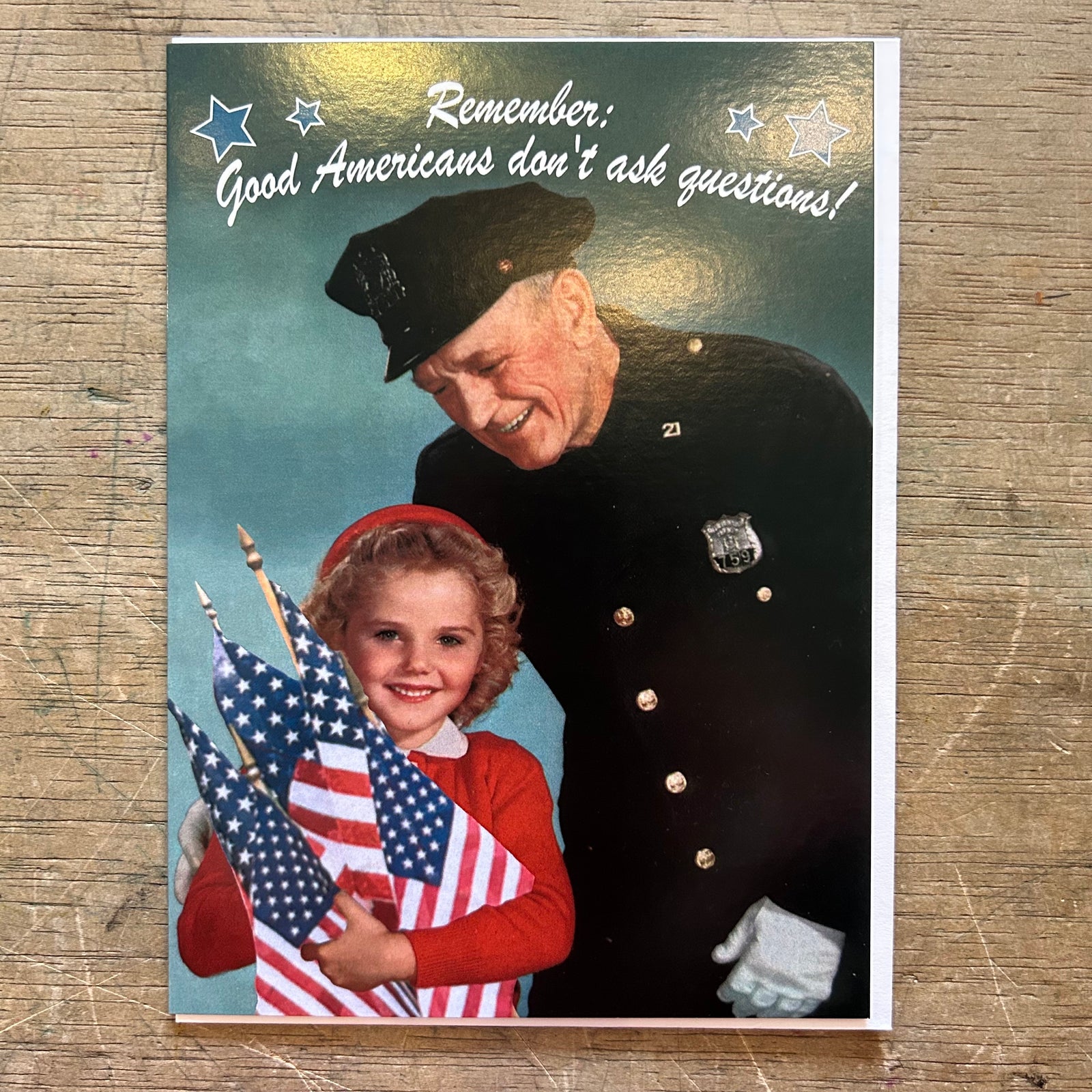 Vintage-style poster with a man in uniform and a child holding American flags, text 'Remember: Good Americans don't ask questions!' on a white background.