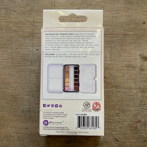 Back of a watercolor set packaging on a wooden surface