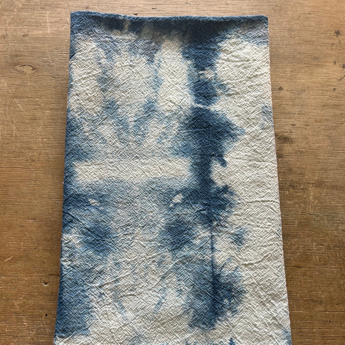 Blue and white indigo dyed towel on a wooden surface
