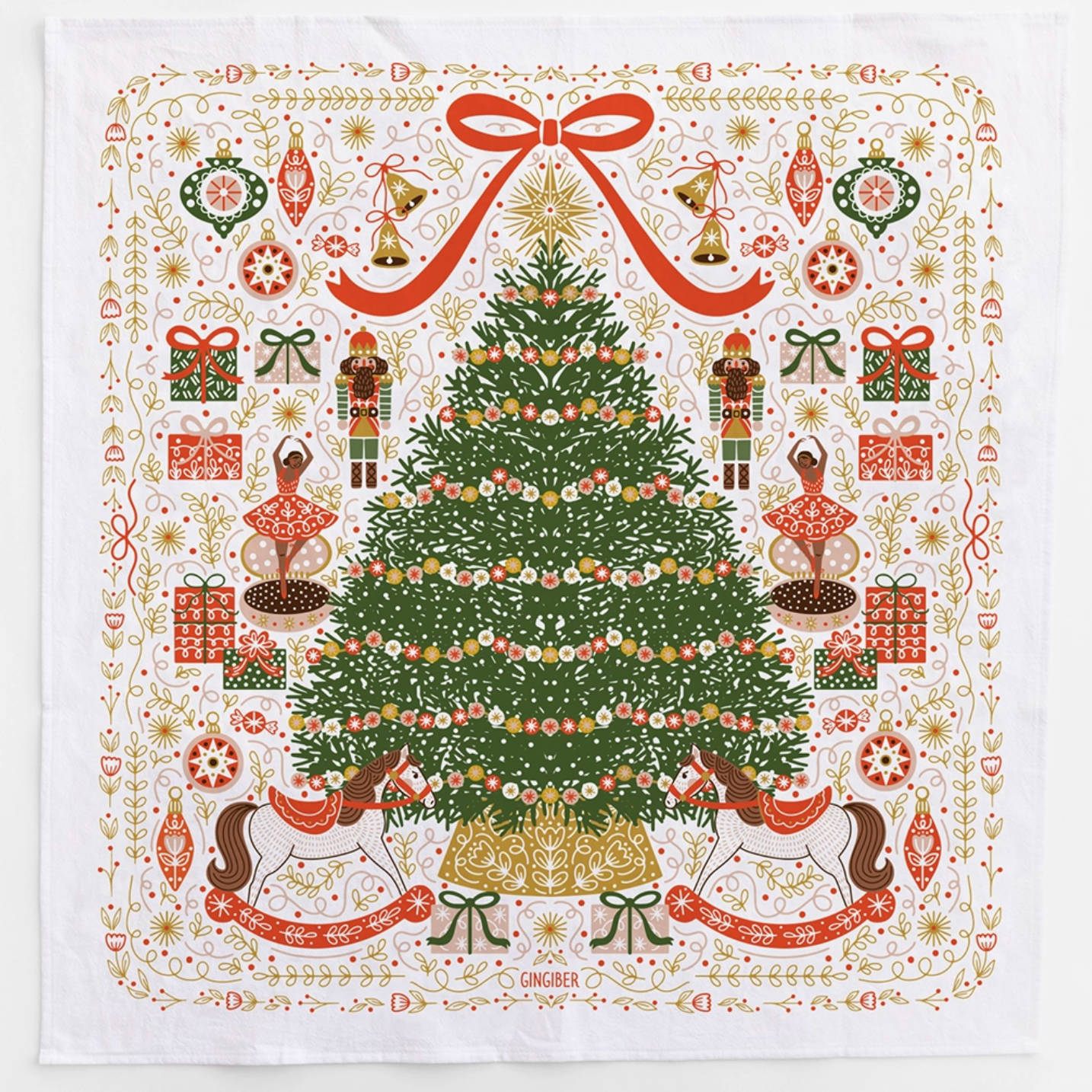 A kitchen towel with an ornate Christmas tree design. Includes illustrations from the 12 Days of Christmas and there is a big, red bow on the top of the tree.
