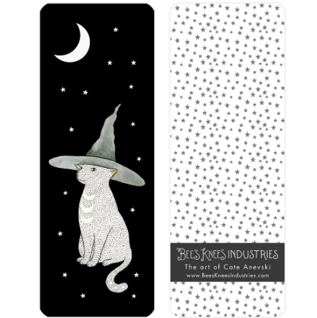A bookmark with an illustration of a cat wearing a witch's hat underneath a crescent moon on one side and gray stars on a white background on the other. 