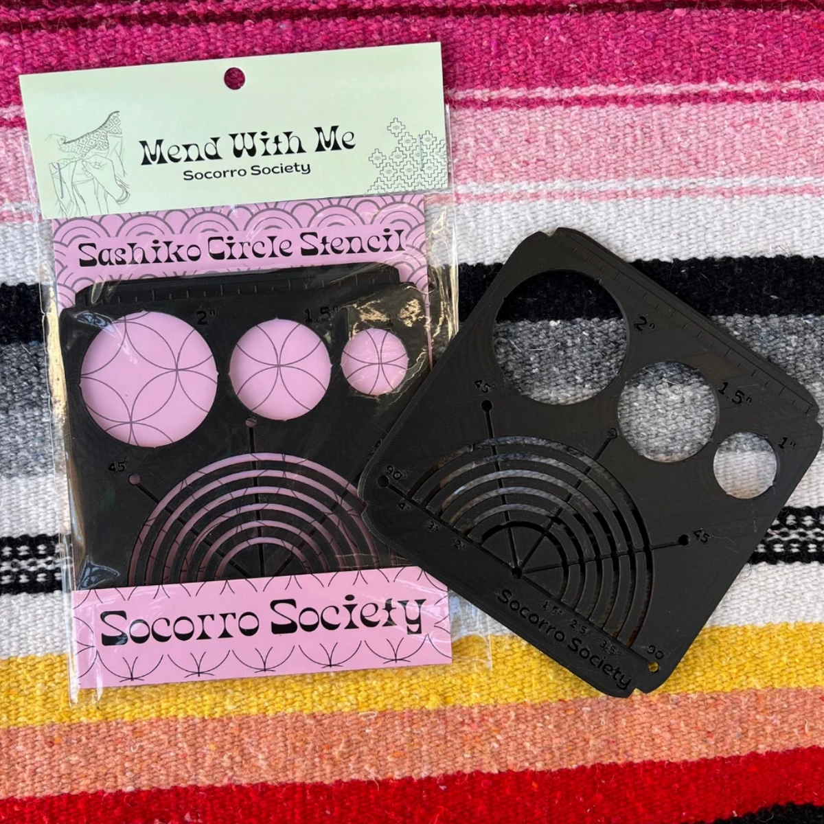 Sashiko circle stencil with packaging on a colorful striped background