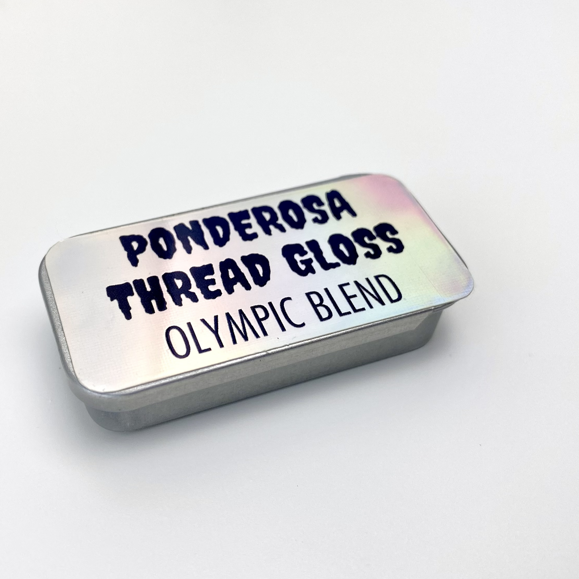 A metal tin of Ponderosa Thread Gloss - Olympic Blend - against a white background.