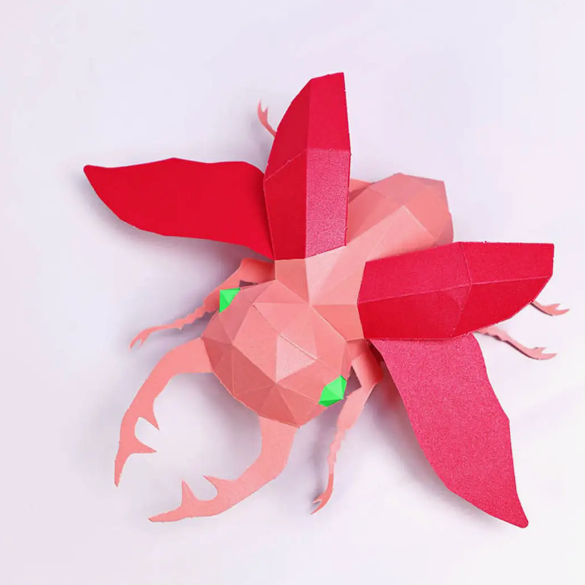 A completed example of a beatle paper craft kit against a white background.