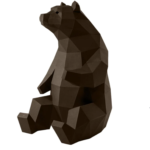 An example of a completed paper craft kit of a bear sitting down against a white background. It is shown from the side.