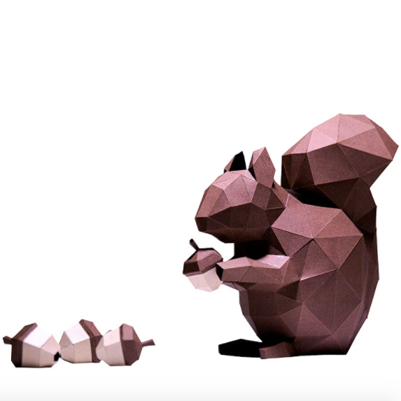 A completed squirrel paper craft kit with tiny paper acorns.