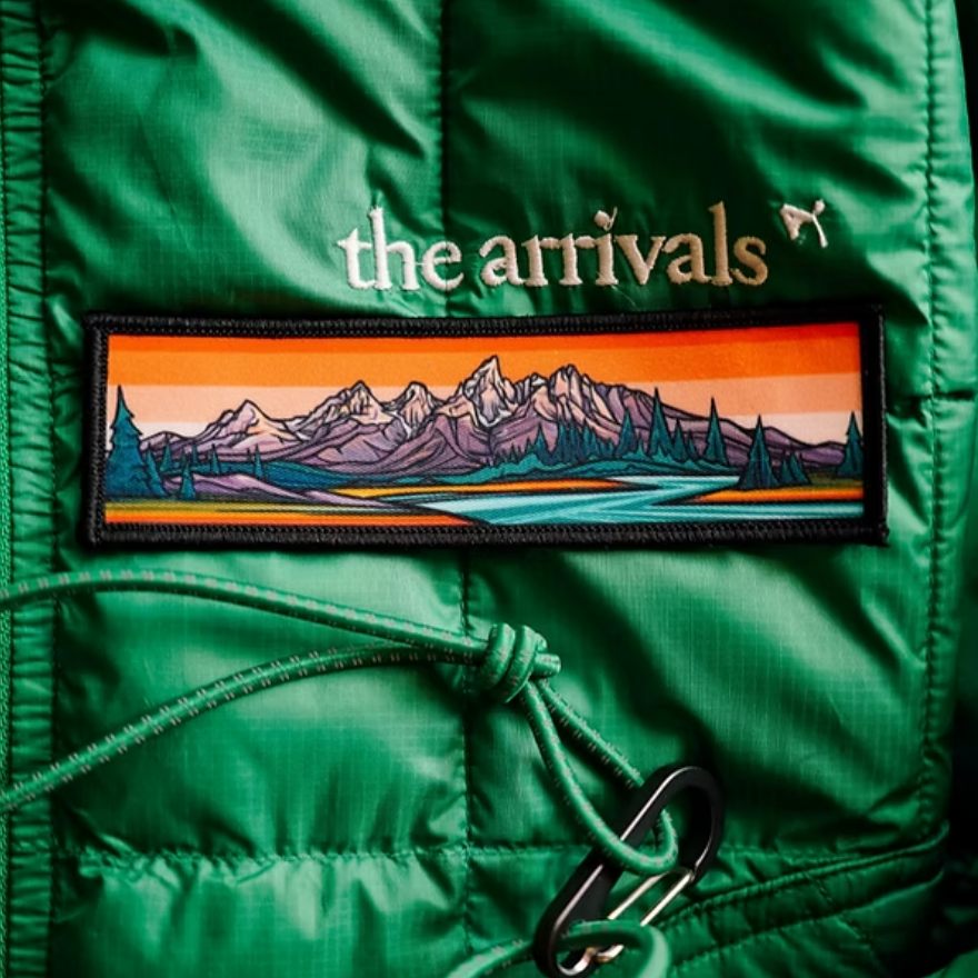 Green jacket featuring a Grand Tetons mountain landscape design.