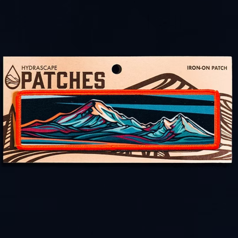Iron-on patch with mountain design on a black background
