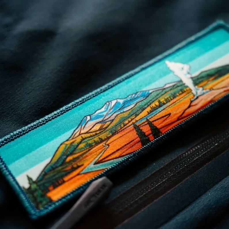 Embroidered patch with Yellowstone mountain and landscape design on a dark fabric background