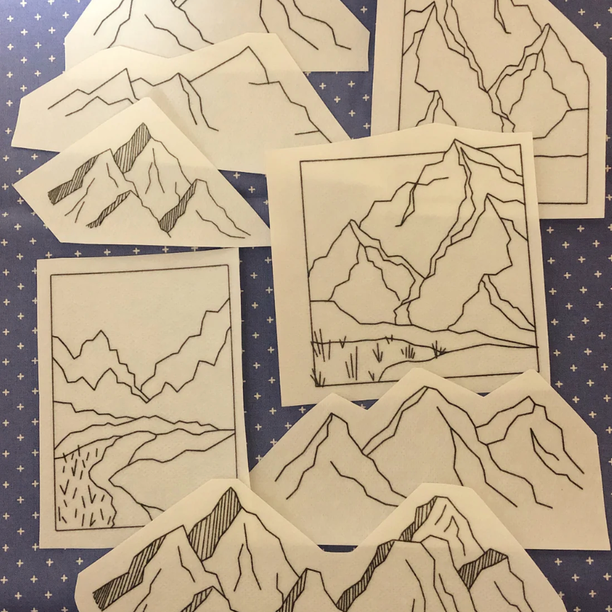 Set of mountain-themed line art prints on a blue starry background. 
