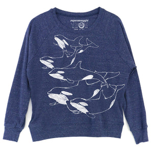 A blueberry colored crewneck sweatshirt featuring a white line art graphic of four orcas on the front, with the 'supermaggie' brand logo printed inside the collar.