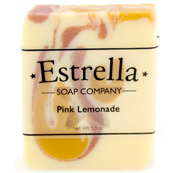 A bar of Estrella soap with a pink lemonade scent, swirled design in pink and yellow colors, with packaging that includes the brand name and product title.