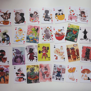 Collection of playing cards with cat-themed illustrations on a white background.