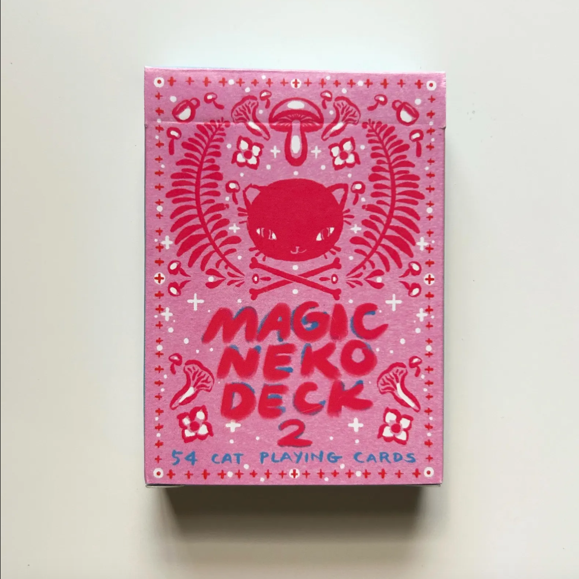 Pink 'Magic Neko Deck 2' playing cards with cat illustration on a white background. 