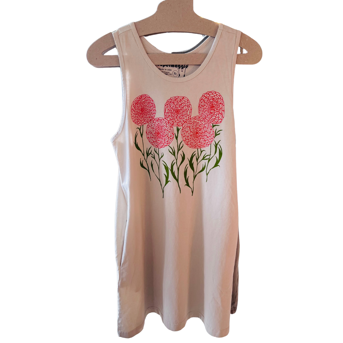 A sleeveless french gray tank dress on a cardboard hanger, featuring a graphic of orange flowers with green stems and leaves on the front.