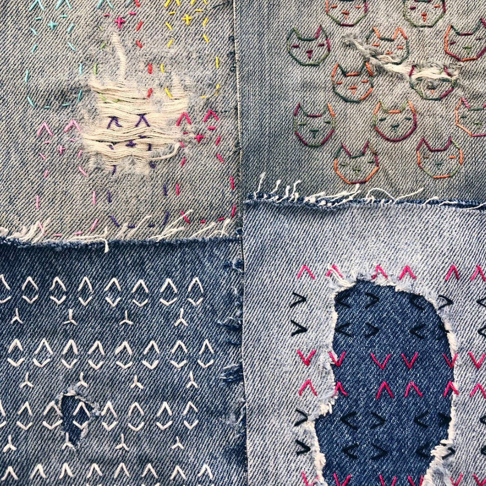 An example of each of the four cat themed designs is stitched onto denim.