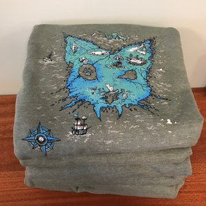 Stack of gray t-shirts with blue and black designs on a wooden surface. 