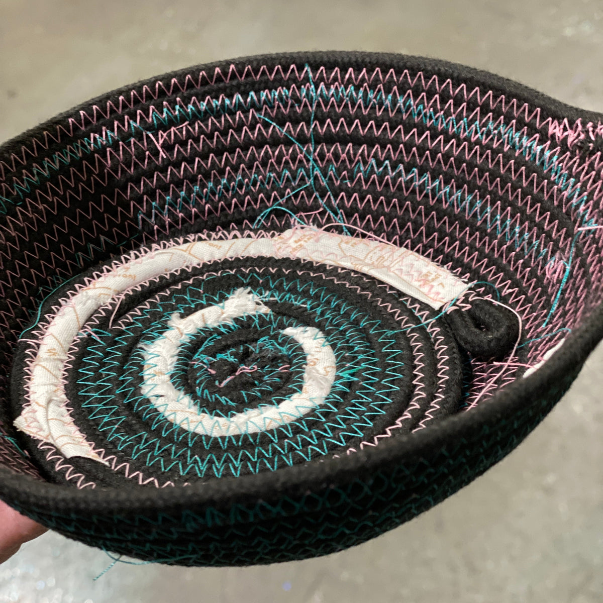 Close-up of a rope bowl on a neutral background.