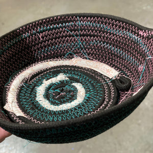 Close-up of a rope bowl on a neutral background.