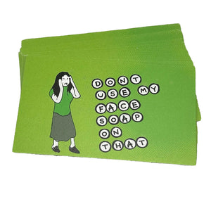 A stack of bright lime green stickers featuring a cartoon illustration of a woman and the text 'DON'T USE MY FACE SOAP ON THAT' in white letter circles, photographed on a neutral light gray background.