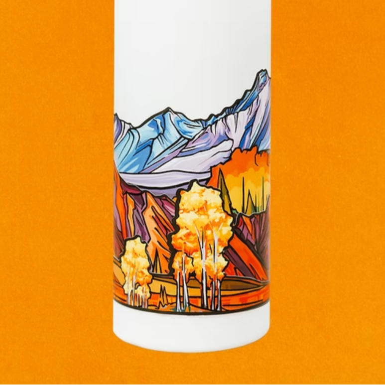 White water bottle with mountain and forest design on an orange background