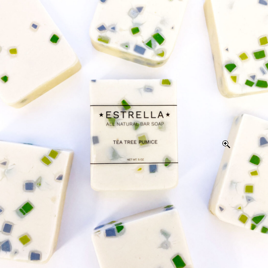 7 bars of tea tree pumice soap. The bars are cream colored with chunks of different green and blues.