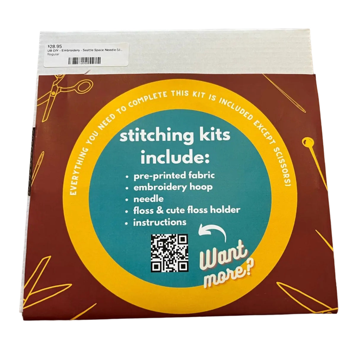 A square product box for an embroidery kit. The box has a dark red background with a large teal and yellow circular label reading 'stitching kits include:' and listing included items such as pre-printed fabric, embroidery hoop, needle, floss, and instructions.