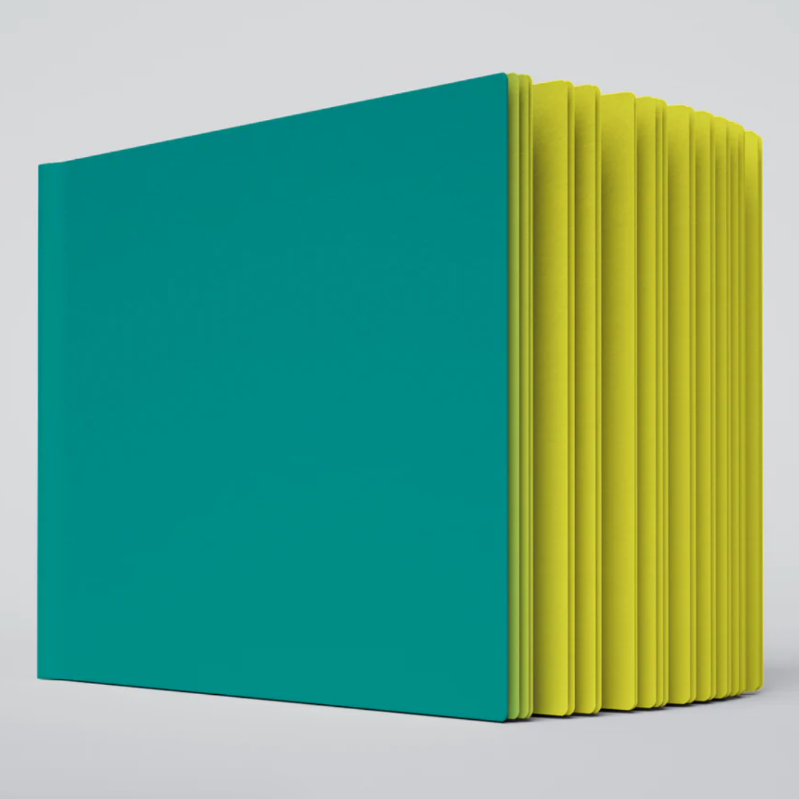 A close up photo of the Lemon Shock ugly book sketchbook. The cover is green and the pages are bright yellow colored.