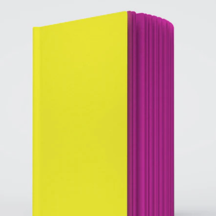 A close up photo of the Razzle Dazzle ugly book sketchbook. The cover is bright yellow and the pages are hot pink colored.