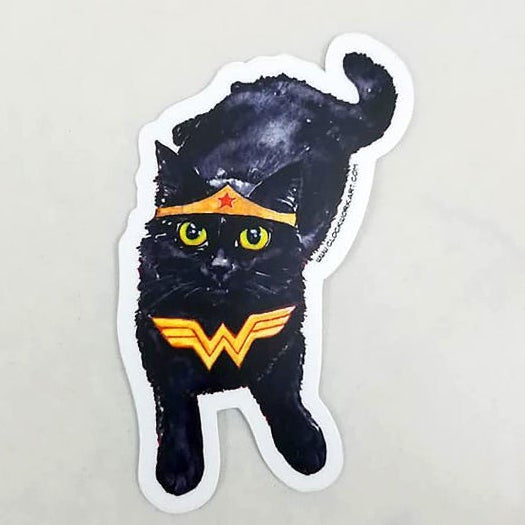 Black cat dressed as Wonder Woman in sticker format against a white background. 