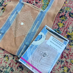 Textile piece with circular pattern and a pattern on a colorful fabric background