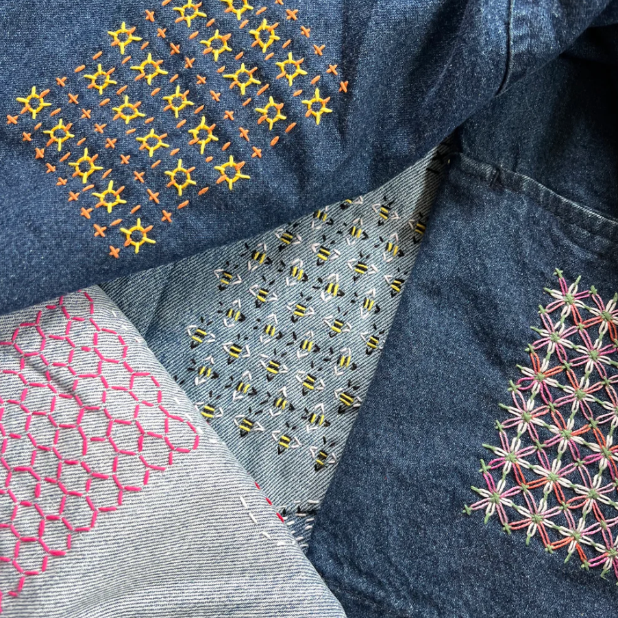 Stitched examples of the four different sashiko style washable mending transfers included in this package. One looks like little bees.