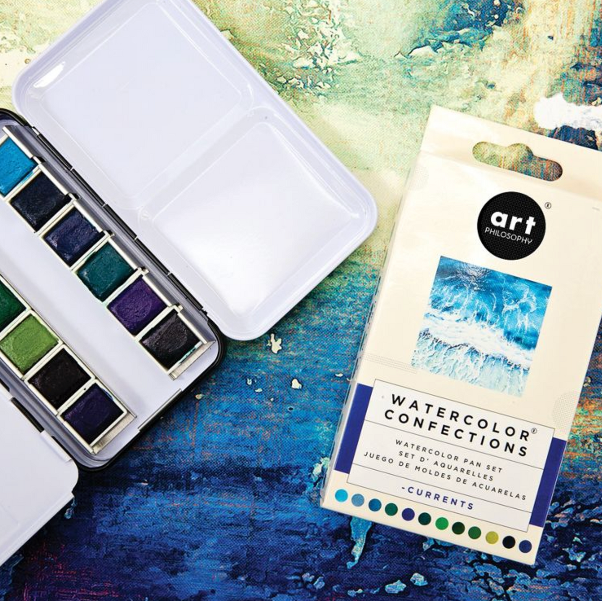 Watercolor paint set with a color swatch on a textured surface