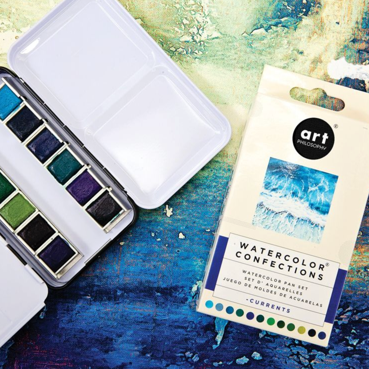 Watercolor paint set with a color swatch on a textured surface