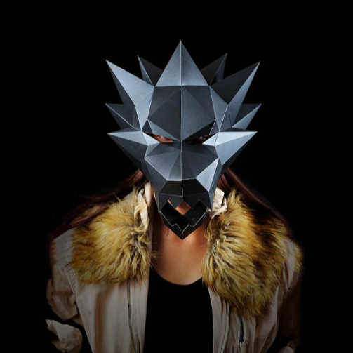 A person in a fur coat wearing a completed werewolf mask paper craft kit.