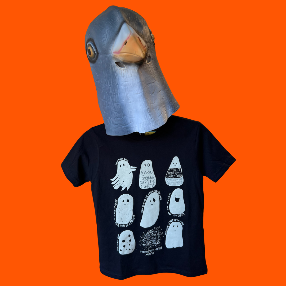 A child wearing a black graphic t-shirt with a white ghost print and a pigeon mask, set against a solid bright orange background.