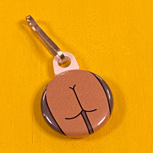 Zipper pull with a flat butt on a yellow surface.